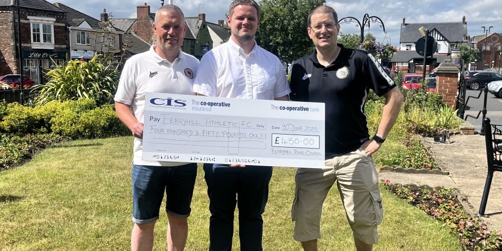 Councillor J Quinn presents cheque