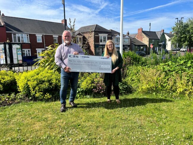 Councillor A Ferguson presents cheque